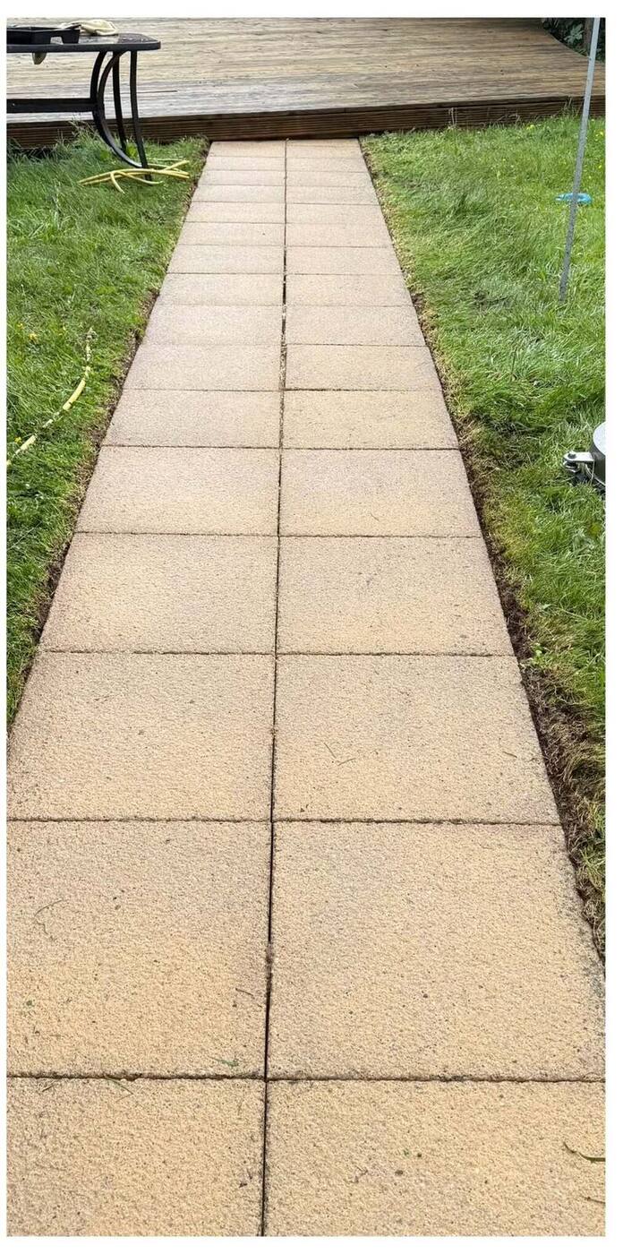 The same path cleared, cleaned, with crisply cut turf edges