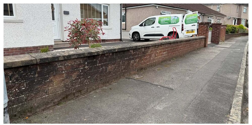 Grimy garden wall with the Take the Pressure Off van parked alongside
